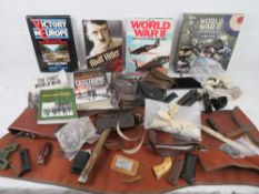 A large quantity of books including the WWII, First world war, a box of DVDs of WWII, gun cases,