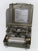 A transit case containing a British Army Land Rover Crew cooker, having British markings upon.