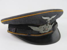 A WWII German Luftwaffe NCOs visor cap, size 57, slightly a/f.