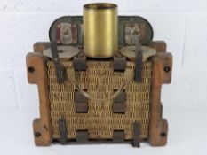 A WWII German transit basket dated 1935 containing a quantity of six 110mm shells.