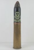 A WWI Canadian HE explosive 18pr dated 1916, the head bearing skull 1914-1918 trench art upon.