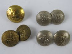 An unusual brass button by Gaunt London having man with flaming torch at waterside.