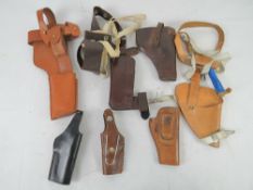 A quantity of seven holsters including a Broomhandle mauser, a colt pythan, s&w,