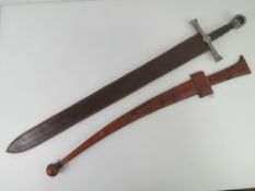 A Sudanese sword with double edged steel blade and leather hilt with matching leather scabbard.