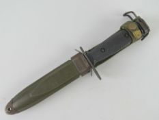 A Vietnam era M16 bayonet with scabbard and canvas frog.