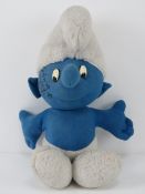 A Chad Valley plush Smurf signed by Barron Knights, creators of the Smurf song.