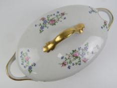 A French lidded turn having white ground with delicate pink and blue floral decoration upon,