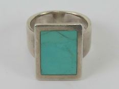 A HM silver turquoise ring, panel at front measuring 1.9 x 1.4cm, hallmarked for Sheffield, size M.