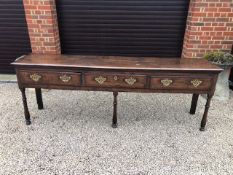 A fine Georgian elm top and oak dresser base, three drawers cross banded with walnut,