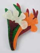 An overlaid plastic brooch in the style of Lea Stein in the form of a floral bouquet,