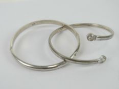 A silver cuff bangle having white stone terminals, stamped 925.