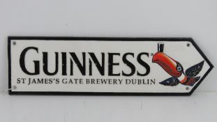 A contemporary cast metal Guinness sign, 38cm in length.