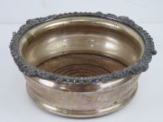 A silver plated wine coaster having turned wooden base with green baize upon, 17cm dia, 12.