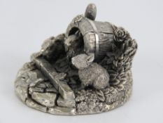 A HM silver Country Artists sculpture of three rabbits in a garden border, signed to back,