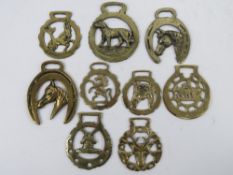 A quantity of assorted contemporary horse brasses of various themes. Nine items.