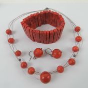 A 925 silver wire necklace having red bead decoration upon,