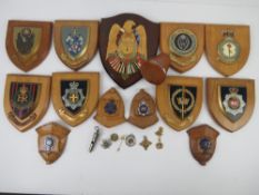 A quantity of assorted wooden plaques having police and military insignia upon,
