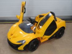 A battery operated childs McLaren P1 car in yellow, in 'as new' boxed condition,