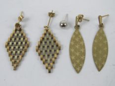 A pair of 9ct gold stud earrings having marquise shaped drops with engraved star pattern upon,