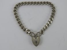 A HM silver heavy curb link bracelet having heart padlock clasp,