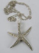 A large silver starfish pendant encrusted with white stones, stamped 925, approx 2.5cm in length, 3.
