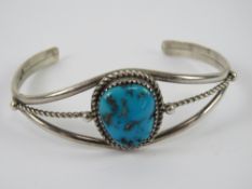 A Richard Begay Native American (Navajo) sterling silver cuff style bangle set with turquoise,