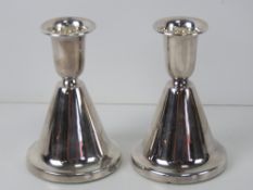 A pair of silver Chrisophersen short candlesticks,