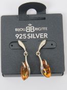 A pair of silver and Baltic amber stud earrings, 3.4cm in length, unused on original packaging.