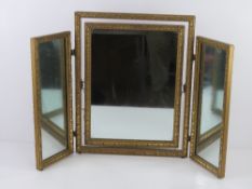 A gold painted tryptic dressing table mirror standing 50.5cm high approx 63cm wide standing.