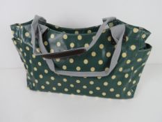A green polka dot pattern handbag 'as ne