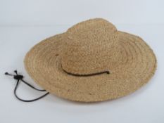 A handmade raffia straw hat made by Scal