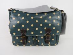 A green polka dot satchel type handbag '
