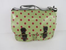 A green polka dot satchel type handbag '