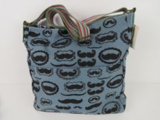 A fabric tote bag having mustache patter