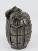 A WWII British Mills grenade with spoon and pin, bearing TA S markings upon.