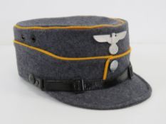 A WWII German NSFK (National Socialist Flying Korp) Kepi peaked cap bearing makers mark and size 57