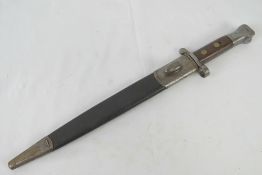 A Lee Enfield bayonet with scabbard, dated 1894 with WD markings and serial number 745 upon.