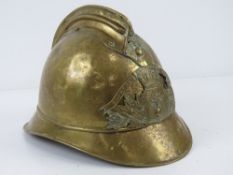 A WWII French Firemans helmet with chin strap.