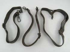 Three MG34 leather slings having metal clips at each end.