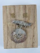 A WWII Japanese boxed Patriotic Ladies Society ordinary member medal.