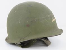 A US M1 helmet with Vietnam liner.