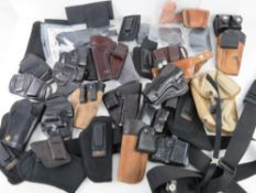 A quantity of assorted modern holsters, ammo pouches and belts including; Mitch Rosen,