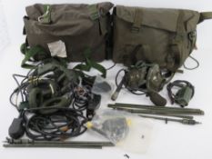 Two British Military Radio headsets having cables and switches, in British transit bags.
