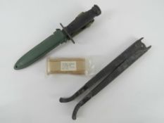 An M16 bayonet with scabbard, M16 bipod legs and an unissued M16 sling.