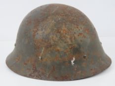 A WWII Japanese helmet with liner.