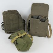 A US M17A2 gas mask bag together with a WWII British gas mask bag and a Military field telephone.