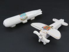 Two items of British WWI crested ware being and aeroplane and a zeppelin.