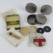 Three WWII German gas mask spare lenses together with a WWII German medics tin and accessories.
