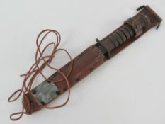 A reproduction M6 fighting knife with scabbard.