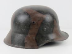 A reproduction WWI German M16 camo helmet with liner.